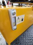 DM12-C hydraulic oil tank: sight glass level gauge with temperature scale and the fill-spec decal on the yellow body