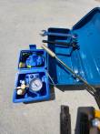 Included tool kit: blue metal box with two wrenches, a drift punch, and a nitrogen charging gauge