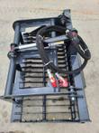 Landhonor rock grapple, hydraulic clamp cylinder and braided hoses above the spaced steel tines