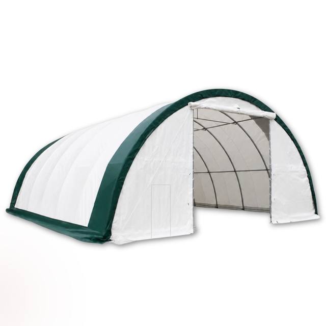 White fabric building with green trim, roll-up door raised to show truss interior