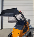 ATS-T460 mini skid steer with the loader arms raised and bucket held high over the vented engine cover