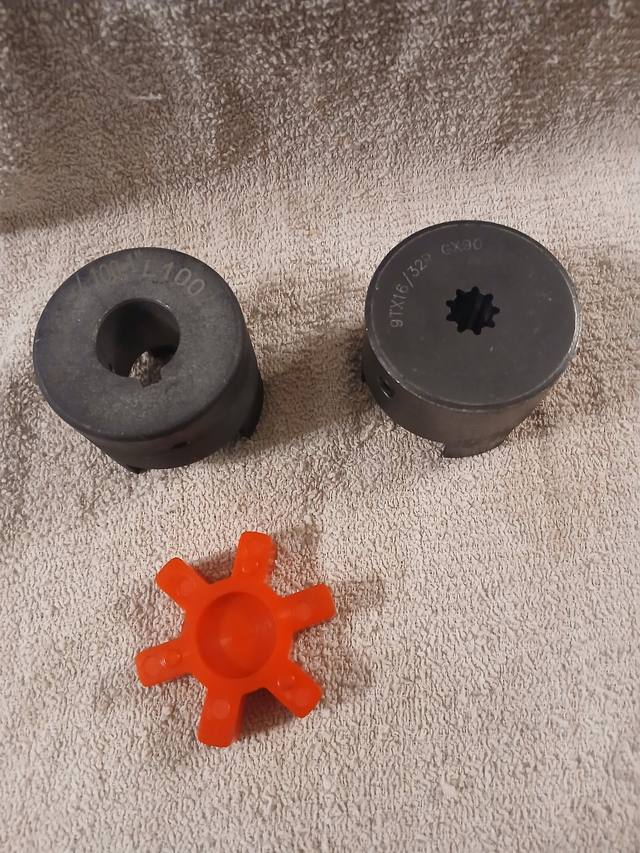 Lovejoy coupling set: two steel jaw hubs, one splined, and an orange urethane spider insert