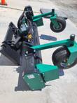 Soil conditioner at an angle: two green gauge wheels on swing arms, toothed drum and end drive housing