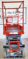 Skyjack SJIII 3226 scissor lift raised, scissor stack extended indoors