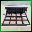 Black steel land leveler attachment: open grid leveling frame and upright moldboard blade with quick-attach mount