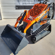 AGT YSRT14 stand-on mini skid steer, orange with gray bucket, rubber tracks, LED work light and YSRT14 decal