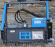 Raytree drum mulcher, 12-24 GPM decal on the blue motor housing beside the pressure gauge