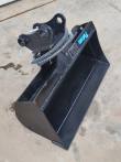Black tilt bucket tipped back, twin pin-eye mounting head, tilt cylinder and coiled hydraulic hoses