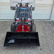 Future FT323TZ wheeled mini skid steer from behind, front bucket visible past the engine cover