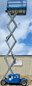 Blue Genie GS-3369RT scissor lift fully extended, scissor stack raised to full height with work platform up top