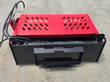 GIYI Mini Rock Rake's black skid steer quick-attach plate and hydraulic couplers, underside of the red frame