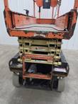JLG 1932R scissor lift, end view showing the entry ladder and platform