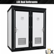LUX Dual Bathrooms graphic: white two-door portable restroom with black steel frame, restroom symbols and louvered vents