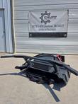 Mini disc mulcher on the ground, quick-attach frame and hydraulic hoses, carbide-tipped cutting disc below
