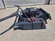 Mini disc mulcher, quick-attach arms and red-capped hydraulic quick couplers on the deck housing