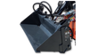 Dark gray 4-in-1 bucket open in clamshell on an orange mini skid steer, arched hydraulic hoses and Wolverine spec decal