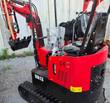 Red and black Miva VA13 mini excavator, rear three-quarter view with canopy frame, seat, control levers and bucket