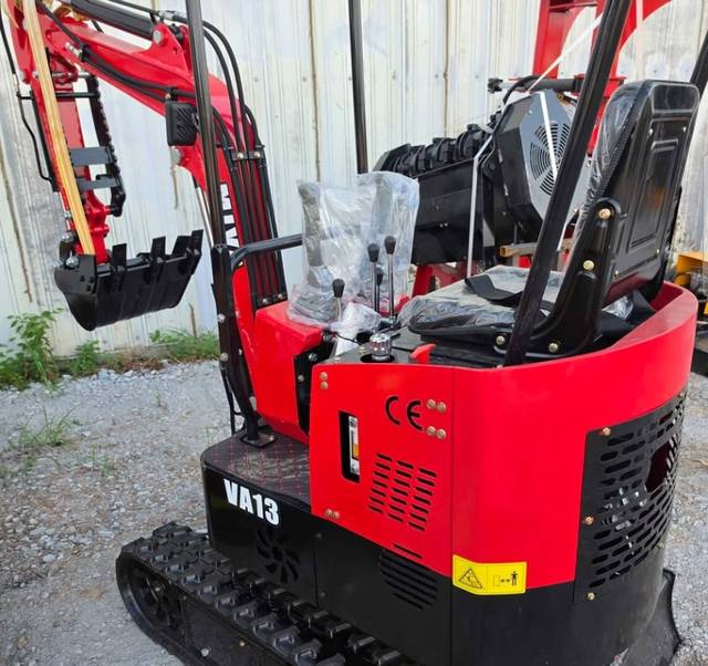 Red and black Miva VA13 mini excavator, rear three-quarter view with canopy frame, seat, control levers and bucket