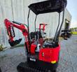 Red and black Miva VA13 mini excavator with rubber tracks, canopy, control levers and digging bucket, side view