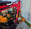 Miva VA13 mini excavator boom with manual thumb, hydraulic hoses and bucket, close-up of the arm joint
