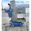 Genie AWP-25S push-around lift: blue base, lowered aluminum mast, steel platform with guardrails, four outriggers