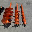 Three orange Raytree auger bits, wide to narrow, showing carbide-tooth tips