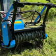 Raytree RMBD50 drum mulcher mounted on a skid steer, mulching tall brush in the field