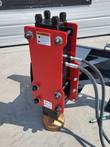 Raytree 680 post driver, red housing, coiled hydraulic hoses, bronze driving cup at the base