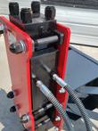 Post driver piston motor block close-up, IN/OUT hydraulic ports and hose fittings