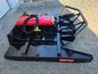 Heavy-duty skid steer brush cutter deck from the side, red hydraulic motor cover and tubular front push bar