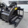 Black root grapple with slotted upper clamp, skid steer quick-attach plate and serrated lower tines