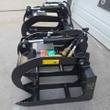Black 72-inch root grapple, both hydraulic clamps open, capped hose couplers routed over the top