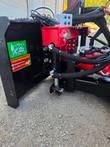 Raytree logo decal on the 6-way dozer blade moldboard, hydraulic cylinder behind it