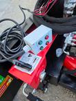 Angle and tilt control box with four buttons, wired into the dozer blade's mount