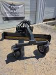 Black Raytree 96-inch grader blade, yellow reversible cutting edge, twin pneumatic casters and quick-attach mount behind