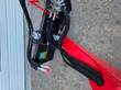 Hydraulic hoses, valve manifold and remote control box mounted on the red arm
