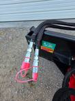 Hydraulic quick-connect couplers with red dust caps, Raytree decal on the deck