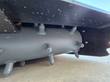 Power rake bucket's rotor drum, rows of pointed teeth mounted along the cylindrical shaft