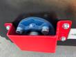 Power rake bucket's end bearing, blue pillow block housing bolted in a red guard
