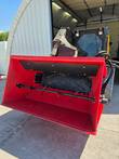 Raytree RSDB72 side discharge bucket, open top with black rubber liner and agitator bar, mounted on a skid steer