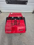 Red tracked remote control mower from above, vented front hood over the Loncin 224cc engine and rubber tracks