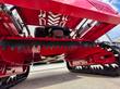 Underside of the red mower: serrated front cutting bar, spinning blade disc, OHV engine and linear actuators