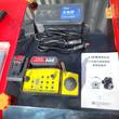 Yellow wireless remote control with joystick, 20V battery, battery charger and Loncin engine manual