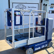 Genie GR-20 vertical mast lift, blue, mast lowered: aluminum platform guardrails, coiled control cord, solid tires