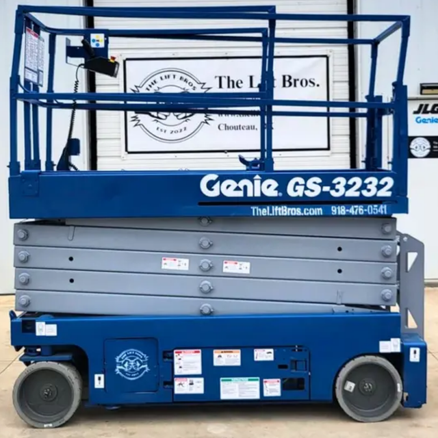 Blue Genie GS-3232 scissor lift, side profile with platform lowered, guardrails up, scissor stack and solid tires