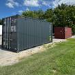 Charcoal gray 20ft high-cube shipping container, closed cargo doors with four steel lock rods