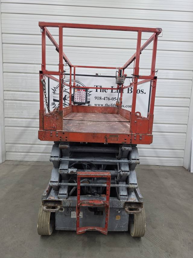 Skyjack SJIII 4632 electric scissor lift, stowed, end view with red platform, rails and gray scissor stack