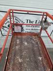 Skyjack SJIII 4632 platform deck, worn diamond plate floor, red guardrails and control box