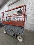 Skyjack SJIII 4632 stowed, three-quarter view from the ladder end with red guardrails and gray chassis