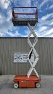 Snorkel S3215L scissor lift, front view, platform fully raised at full height